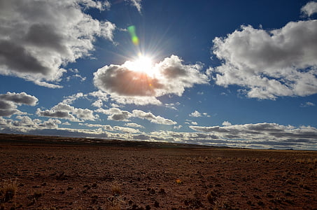 photo of brown pavement under white clouds thumbnail