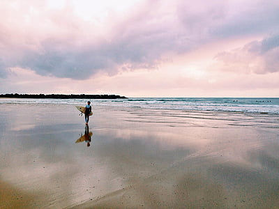 man with surf board on the beacg thumbnail