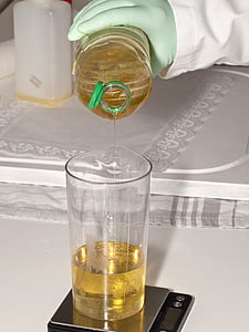 person pouring yellow liquid on clear drinking glass thumbnail