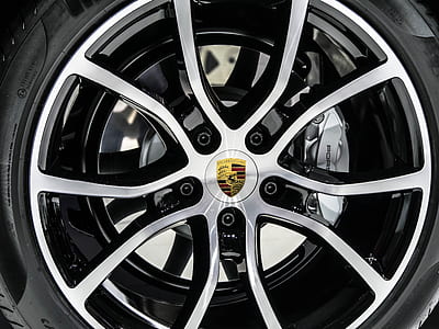 gray Porsche 5-spoke vehicle wheel and tire in close-up photo thumbnail
