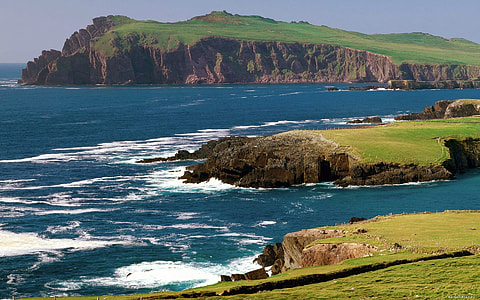 islands covered with grass during daytime thumbnail