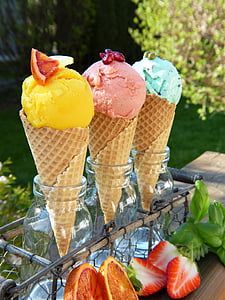 three assorted-color ice cream beside strawberry and grapefruit at daytime thumbnail