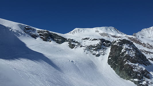 snow-covered mountain under blue sky thumbnail