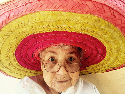 woman in pink and yellow stripe straw sun hat close up photo thumbnail