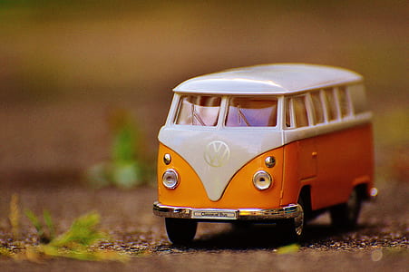 selective focus photo of orange and white Volkswagen T2 die-cast model thumbnail