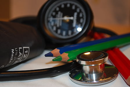 black stethoscope beside blue and green pencils thumbnail