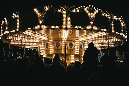 people standing beside carousel thumbnail