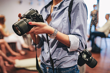 People with cameras at an exhibition thumbnail