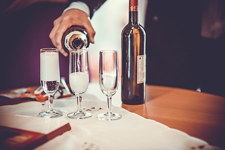 A man pours champagne into drinks glasses thumbnail