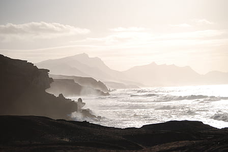 sea waves near rock formation thumbnail
