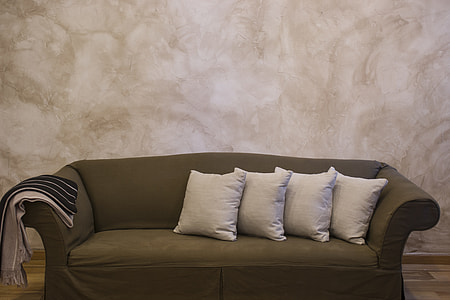 empty gray fabric sofa and four white throw pillows thumbnail