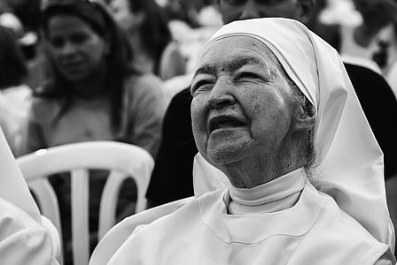 grayscale photo of woman sitting on chair thumbnail