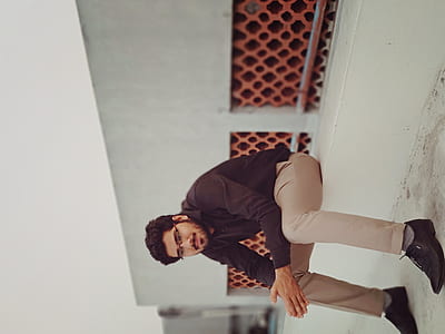 man in black dress shirt sitting on white concrete thumbnail