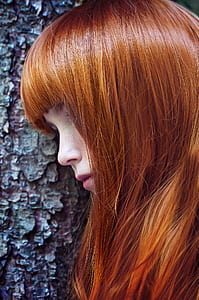 woman with blonde hair leaning on wall thumbnail