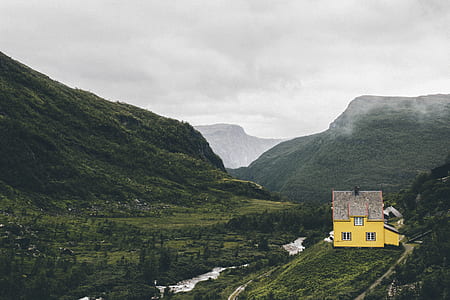 bird's eye view of yellow house of top of mountain thumbnail