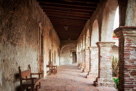 two brown wooden benches near the wall thumbnail