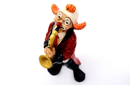 clown using instrument figurine on white surface thumbnail