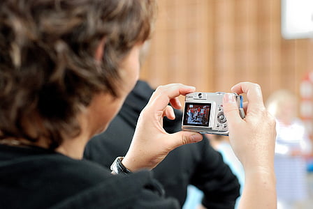 person holding compact camera thumbnail