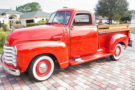 red stake truck park near on grass field thumbnail