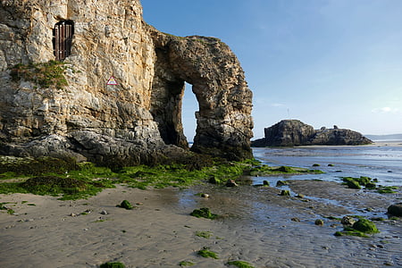 brown rock formation near sea during daytime thumbnail