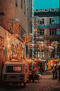 group of people on alley between concrete buildings during daytime thumbnail