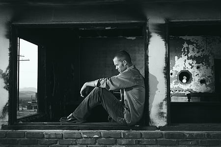 man sitting on window glass thumbnail