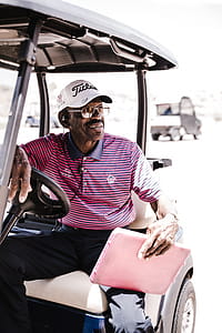 Photo of Man Sitting on Golf Cart thumbnail