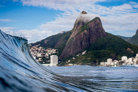 wind wave near mountain with village thumbnail