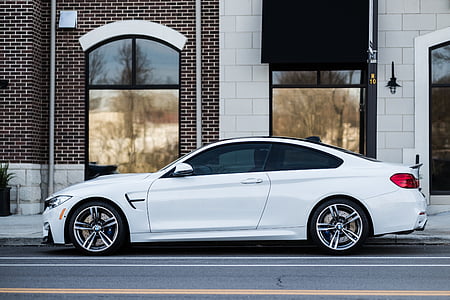 white coupe on street sidewalk thumbnail