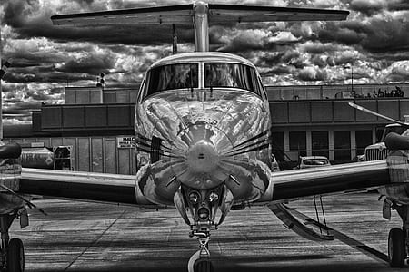 grayscale photo of bi-plane on runway thumbnail