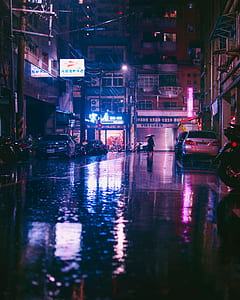 person holding umbrella and walking on street thumbnail