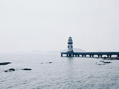 lighthouse on dock during daytime thumbnail