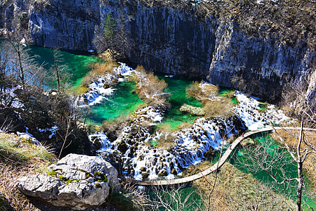 aerial photography of body of water surround by rocks during daytime thumbnail