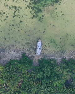 aerial photography of white ship near island thumbnail