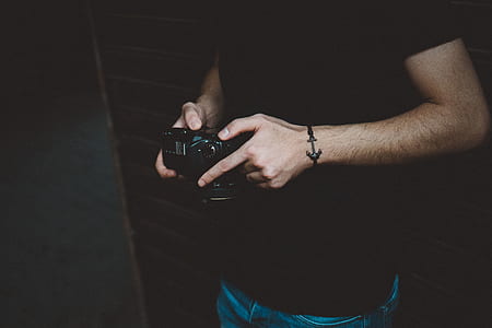 man holding black camera thumbnail