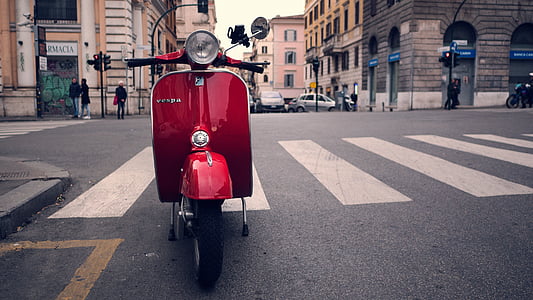 red motor scooter parked on pedestrian thumbnail