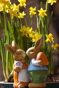 two rabbit figurines near yellow petaled flowers thumbnail