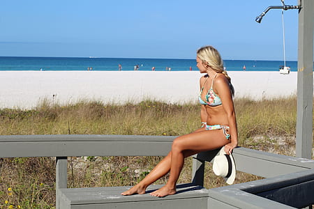 woman sitting on gray wooden fence thumbnail