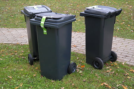 three black rolling trash bins near hallway thumbnail