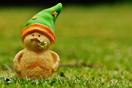 brown ceramic gnome on grass thumbnail