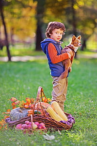 boy holding brown Chihuahua outdoor thumbnail