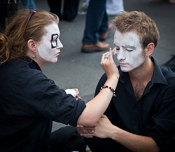 woman doing makeup on man thumbnail