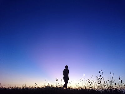 silhouette of person walking outdoor under blue sky thumbnail