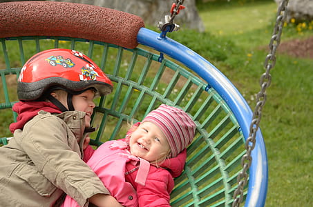 boy and girl playing on swing thumbnail