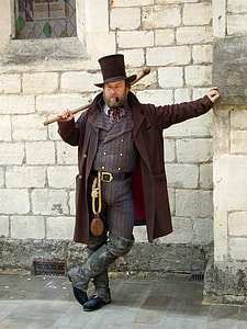 man wearing brown coat and holding brown stick thumbnail