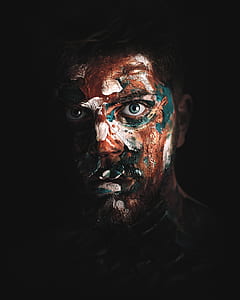 man with brown and blue floral face paint thumbnail