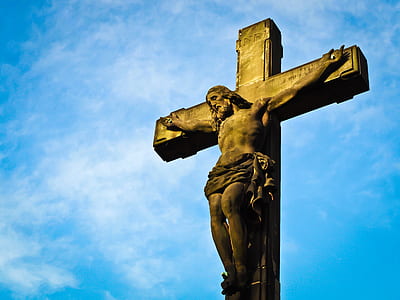 brown crucifix under blue skies thumbnail