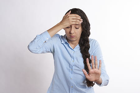 woman wearing blue dress shirt stopping gesture thumbnail