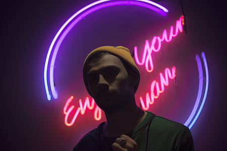 man standing in front of LED signage thumbnail