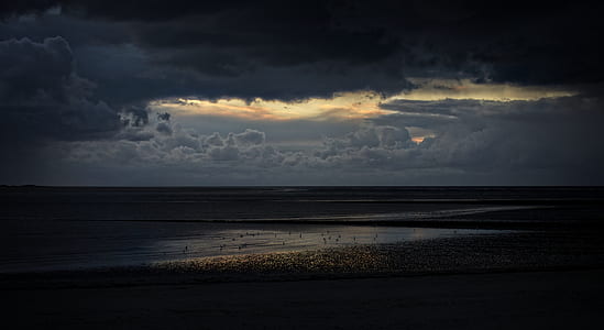 nimbus cloud over body of water thumbnail